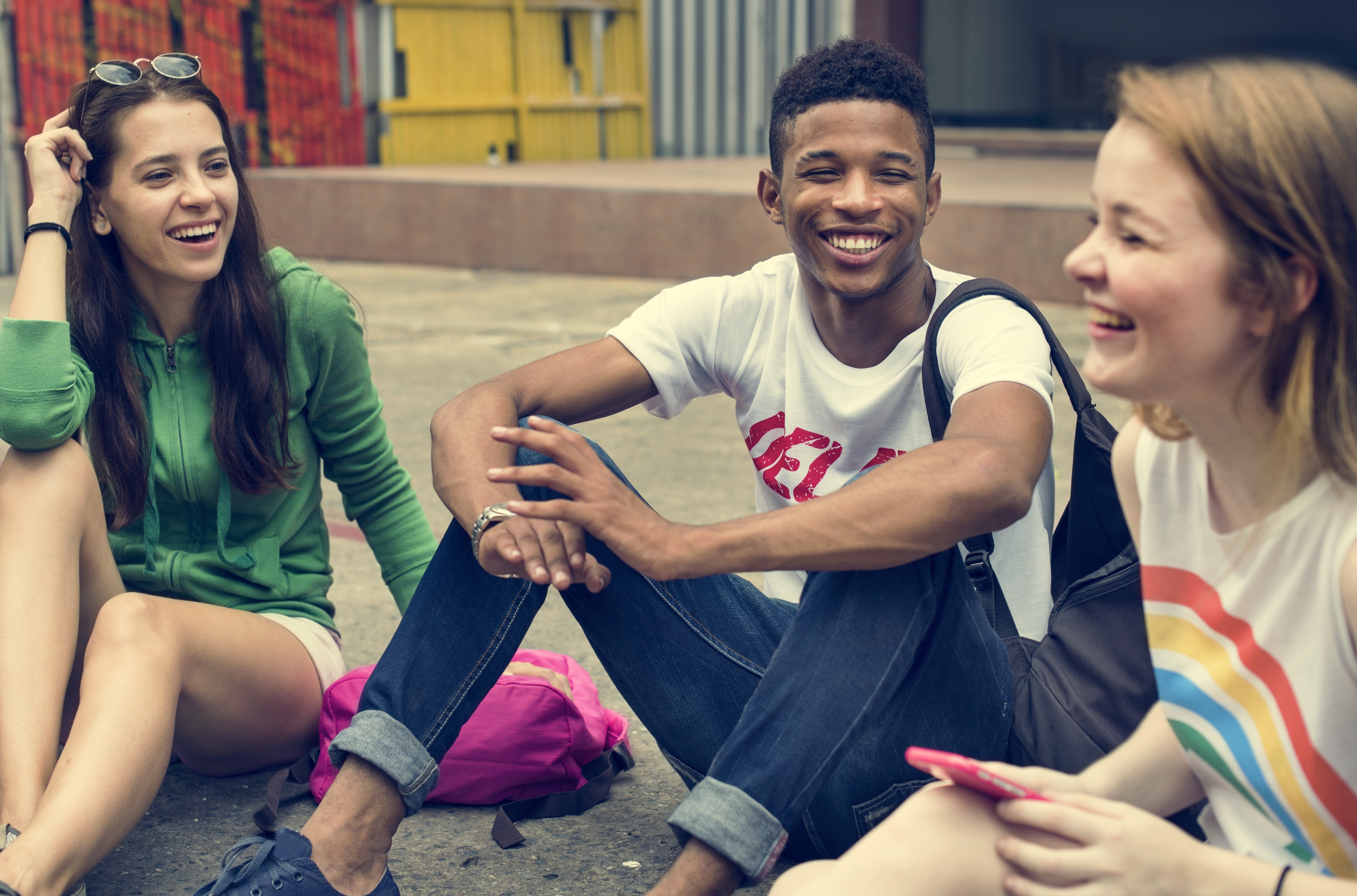 group of youth sitting on the ground