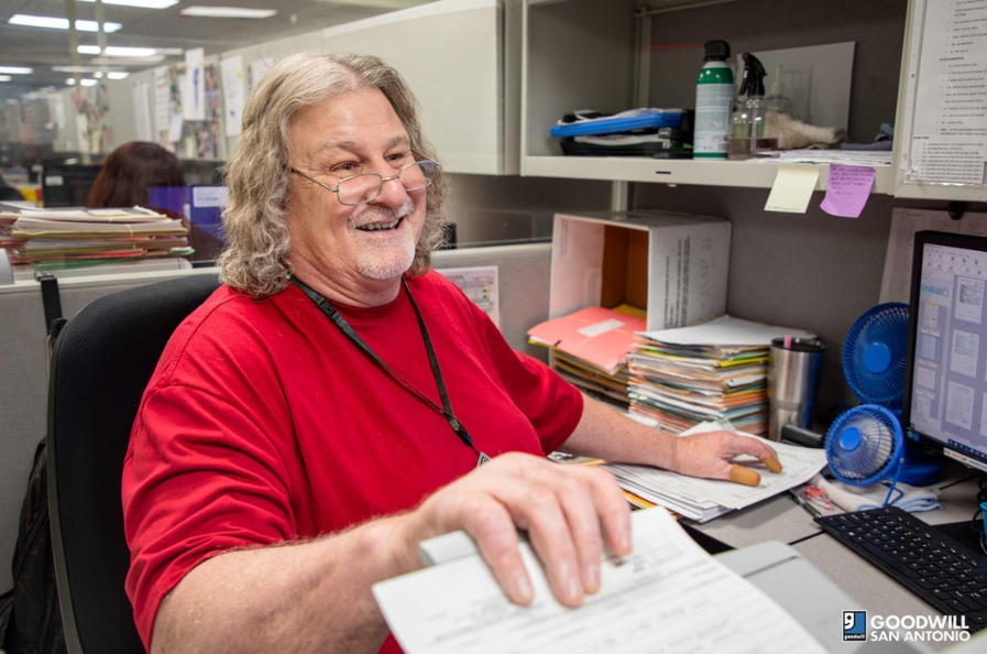 Goodwill Business Service employee, male, glasses, red shirt