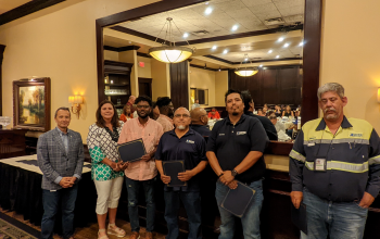 Goodwill Team Members congratulated by Carlos Contreras and Erin Fogarty.y