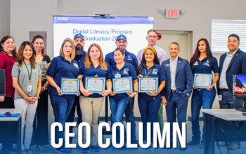 Goodwill San Antonio CEO Carlos Contreras stands with graduates of the digital literacy program.