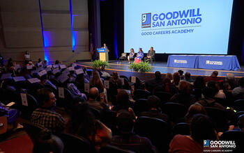 Goodwill San Antonio President and CEO Carlos Contreras speaks in front of the graduating class of the Goodwill San Antonio Good Careers Academy.
