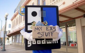 Goodwilliam Mascot holding a box of donated items labeled "My Ex's Stuff"