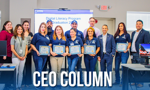 Goodwill San Antonio CEO Carlos Contreras stands with graduates of the digital literacy program.