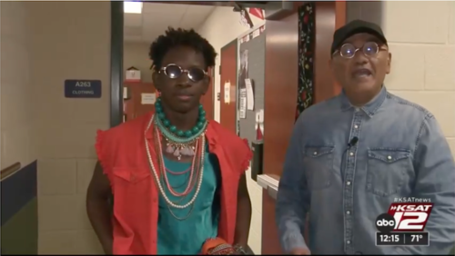 A student from Stevens High School in San Antonio Texas models his Goodwill fashion outfit for the Stevens High School and Goodwill San Antonio Fiesta Fashion Show. Agosto Cuellar stands beside the student providing an interview for KSAT 12.